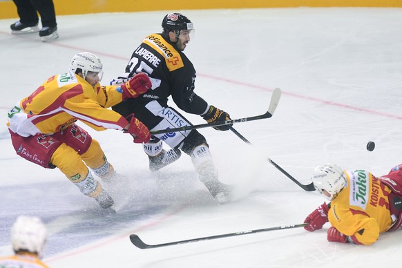 From left: Tiger&#039;s player Miro Zryd, Lugano’s player Maxim Lapierre and Tiger&#039;s player Ville Koistinen during the preliminary, round game of National League A (NLA, LNA) Swiss Championship 2 ...