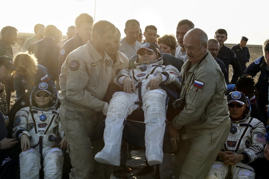 epa06180401 Ground personnel helps to International Space Station (ISS) crew members Russian cosmonaut Fyodor Yurchikhin (C), NASA astronaut Peggy Annette Whitson (L), and NASA astronaut Jack Fischer  ...