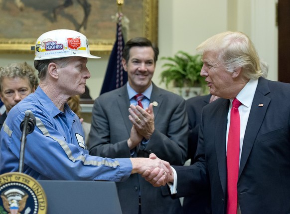 epa05798255 A coal miner identified as Kevin shakes hands with US President Donald J. Trump prior to the President signing H.J. Res. 38, disapproving the rule submitted by the US Department of the Int ...