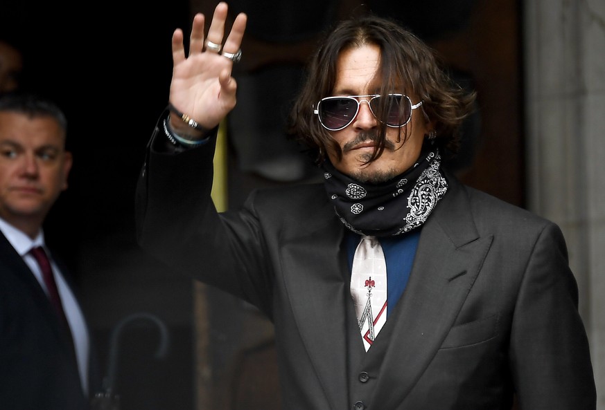 Johnny Depp arrives at the High Court in London, Wednesday July 8, 2020. Johnny Depp is facing a second day of cross-examination by lawyers for British tabloid The Sun, which is defending a libel clai ...