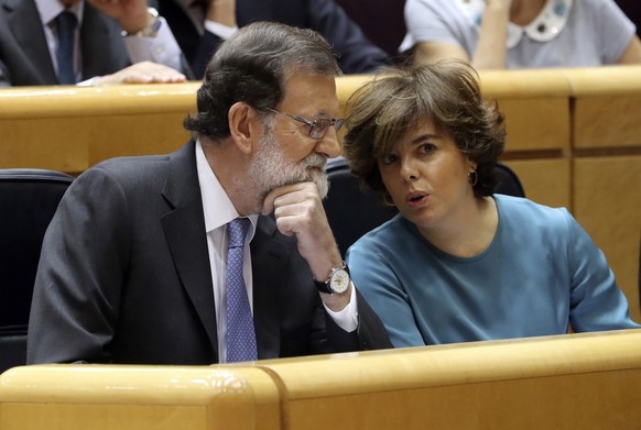 epa06292104 Spanish Prime Minister, Mariano Rajoy (L), chats with Vice Prime Minister, Soraya Saez de Santamaria, prior to the start of the Senate&#039;s extraordinary plenary session on the applicati ...