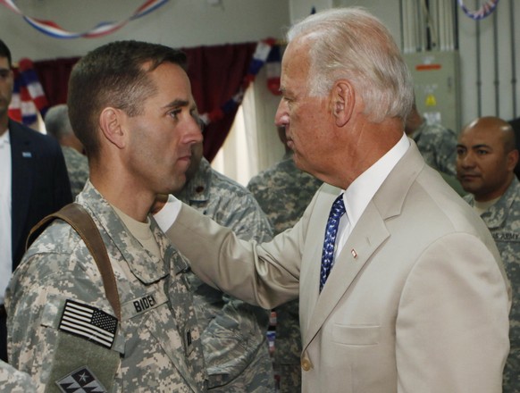 FILE - In this Saturday, July 4, 2009. file photo, U.S. Vice President Joe Biden, right, talks with his son, U.S. Army Capt. Beau Biden, at Camp Victory on the outskirts of Baghdad, Iraq. On Saturday, ...