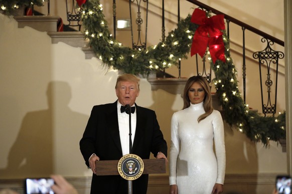 epa07234381 US President Donald J. Trump (L) speaks next to First Lady Melania Trump (R) at the Congressional Ball at the White House in Washington, DC, USA, 15 December 2018. EPA/YURI GRIPAS / POOL