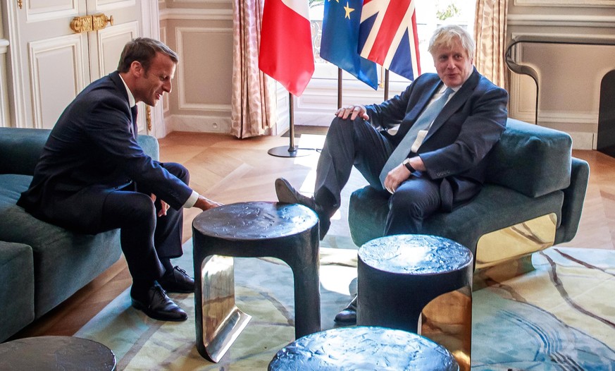 epa07786190 French President Emmanuel Macron (L) and British Prime Minister Boris Johnson (R) during their meeting at the Elysee Palace in Paris, France, 22 August 2019. Johnson is in Paris after a on ...