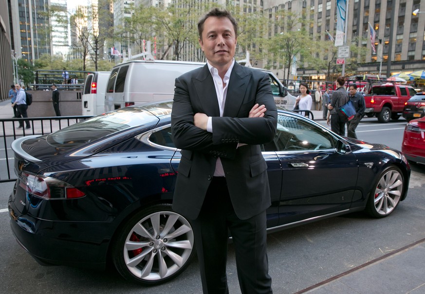 SpaceX billionaire founder and chief executive, and Tesla Motors CEO Elon Musk, poses beside a Tesla, after his interview on &quot;Countdown to the Closing Bell,&quot; on the Fox Business Network, in  ...