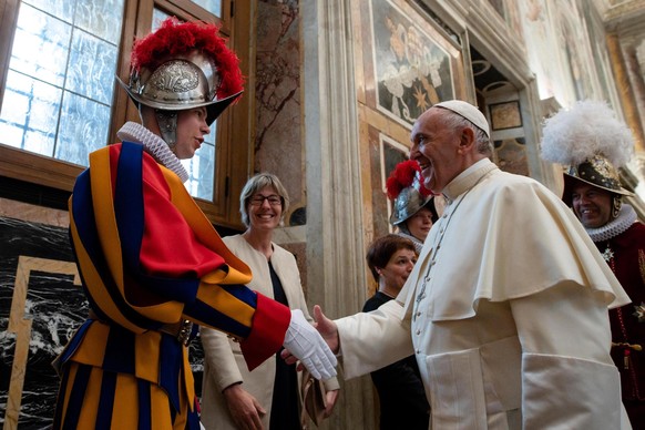 epa06710701 A handout photo made available by the Vatican Press Office shows Pope Francis (R) receiving the Pontifical Swiss Guard Corps, on the occasion of the swearing in of the new Guards, during a ...