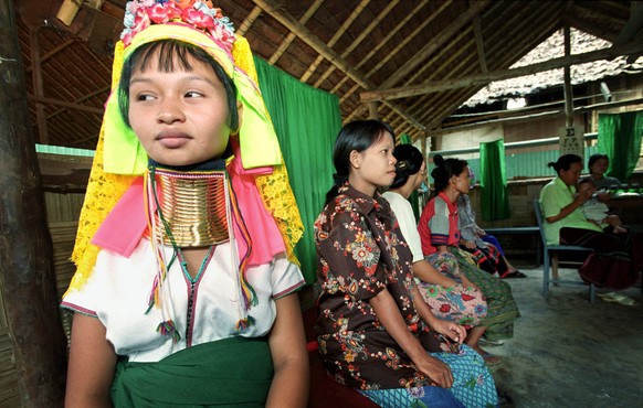 Madah, a Long Neck Karen from Myanmar, waits for medical treatment at a refugee camp near Mae Hong Son, Thailand, Friday, Aug. 16, 2002. Refugees from ethnic groups such as the Karen and the Shan cont ...