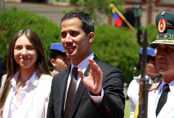 epa07406721 The leader of the Venezuelan Parliament, Juan Guaido (C), and his wife Fabiana Rosales (L) arrive at the Government Palace, in Asuncion, Paraguay, 01 March 2019. Guaido, recognized by Para ...