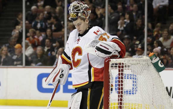 Calgary Flames goalie Joni Ortio, of Finland, stands in front his net after giving up the fourth goal to the Anaheim Ducks, during the second period of an NHL hockey game Wednesday, Jan. 21, 2015, in  ...