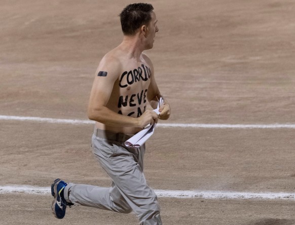 epa07764921 A protester with words &#039;No More Bullfights&#039; written on his chest runs on the bullring prior to a bullfight at the Coliseo Balear bullring in Palma de Mallorca, Balearic Islands,  ...
