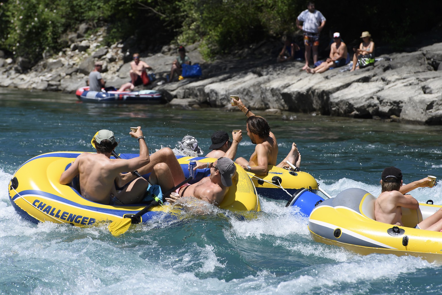 People on inflatable boats enjoy the sun on the Aare River at Uttigen, between Thun and Bern, Switzerland, during the sunny and warm weather, Monday, June 1, 2020. (KEYSTONE/Anthony Anex)