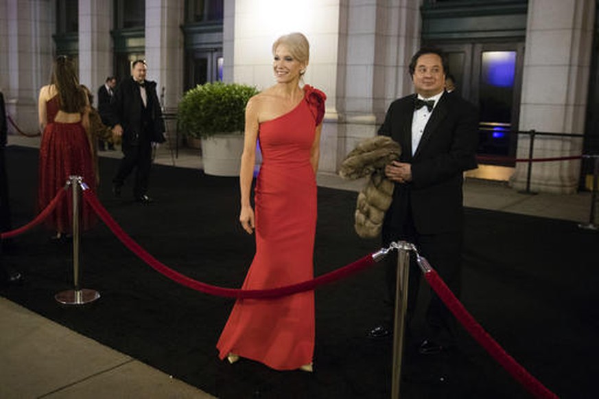 FILE - In this Thursday, Jan. 19, 2017 file photo, President-elect Donald Trump adviser Kellyanne Conway, center, accompanied by her husband, George, speaks with members of the media as they arrive fo ...