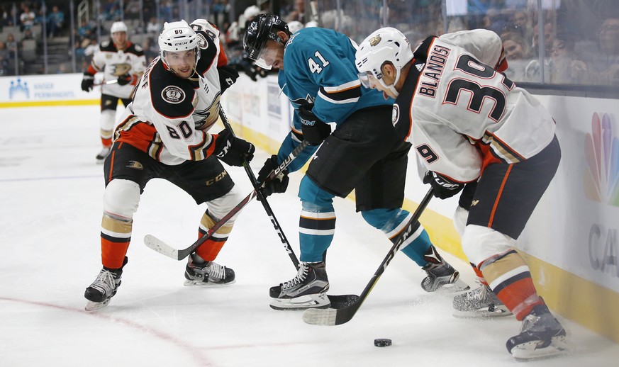 Anaheim Ducks&#039; Deven Sideroff, left, and Joseph Blandisi work for the puck against San Jose Sharks&#039; Vincent Praplan during the second period of a preseason NHL hockey game in San Jose, Calif ...