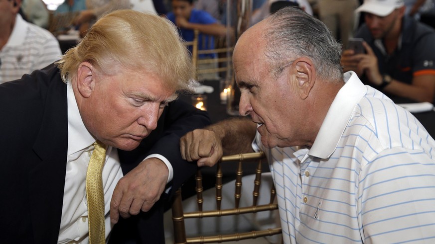 FILE - In this July 6, 2015 file photo, Donald Trump, left, talks the former New York City mayor Rudolph Giuliani at a fundraising event in the Bronx borough of New York. Giuliani, who earned the nick ...