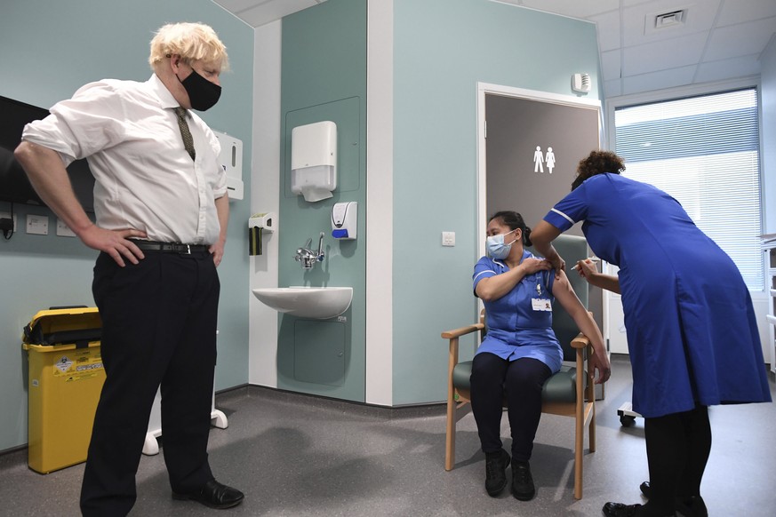 FILE - In this Jan. 4, 2021 file photo Britain&#039;s Prime Minister Boris Johnson watches as nurse Jennifer Dumasi is injected with the Oxford-AstraZeneca COVID-19 vaccine, during a visit to view the ...
