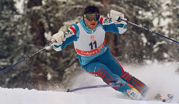 Italian slalom specialist Alberto Tomba swings around the pole as he speeds down the race course to win the gold medal in Olympic special slalom at Mt. Allan, Feb. 27, 1988 in Nakiska, Calgary, Canada ...