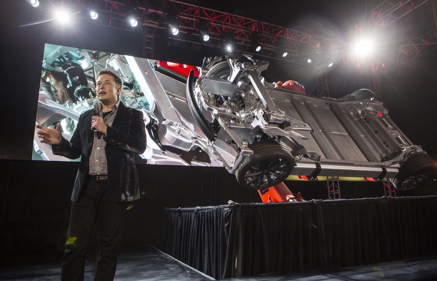 Elon Musk, CEO of Tesla Motors Inc., announces its new car Tesla &quot;D&quot; in Hawthorne, Calif., Thursday, Oct. 9, 2014. (AP Photo/Ringo H.W. Chiu)