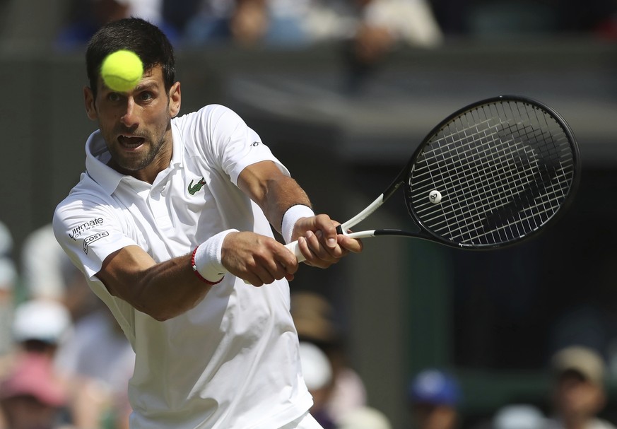 Serbia&#039;s Novak Djokovic returns to Spain&#039;s Roberto Bautista Agut in a Men&#039;s singles semifinal match on day eleven of the Wimbledon Tennis Championships in London, Friday, July 12, 2019. ...
