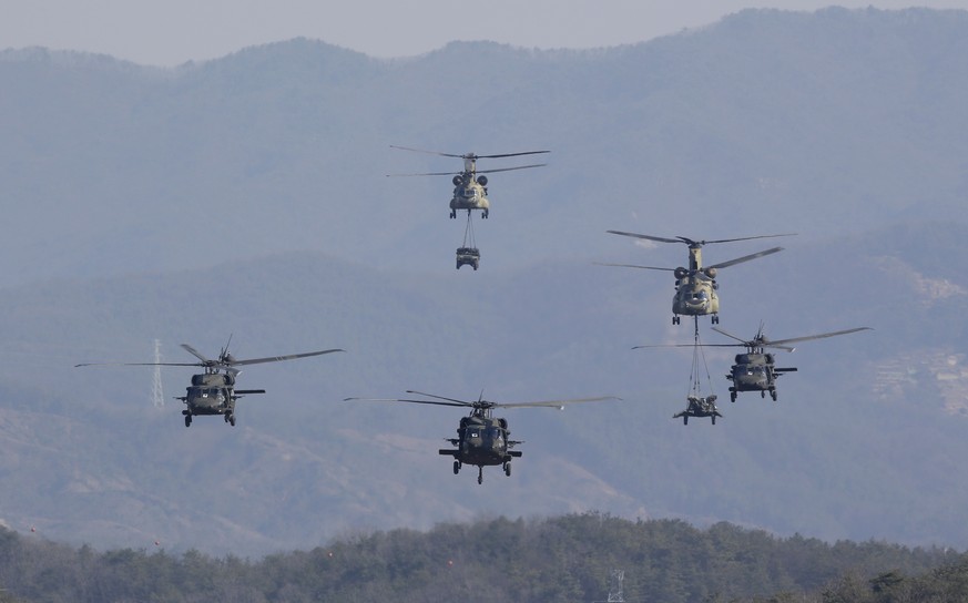 FILE- In this March 25, 2015, file photo, U.S. Army&#039;s Blackhawk and Chinook helicopters fly during a combined arms live-fire exercise during the annual joint military exercise Foal Eagle between  ...