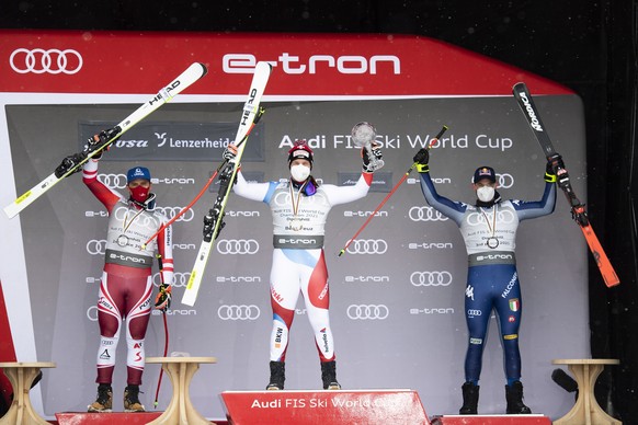 epa09079561 (L-R) Second placed Matthias Mayer of Austria, winner Beat Feuz of Switzerland and third placed Dominik Paris of Italy during the award ceremony for the crystal globe of the men&#039;s dow ...