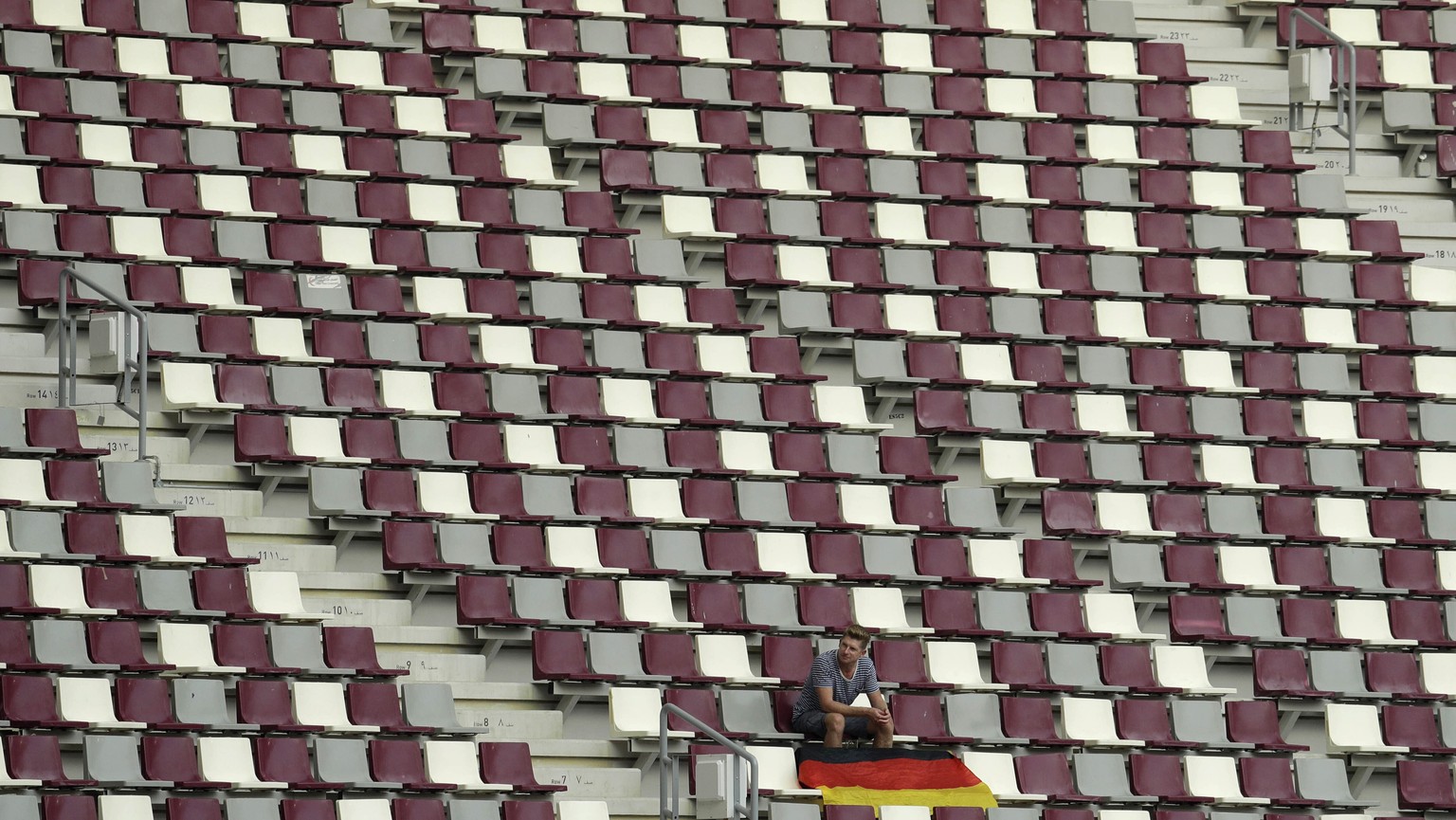 A lone German supporter sits in the stands at the World Athletics Championships in Doha, Qatar, Monday, Sept. 30, 2019. (AP Photo/Nariman El-Mofty)