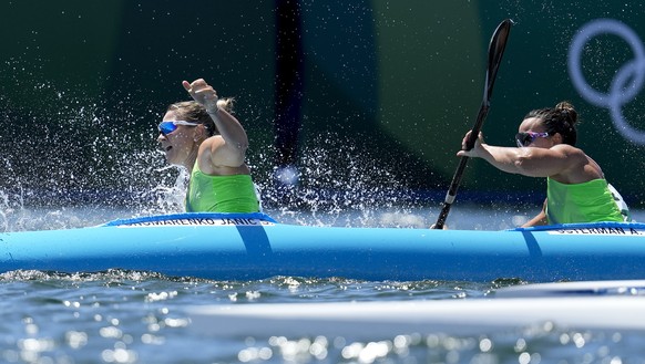 Spela Ponomarenko Janic and Anja Osterman of Slovenia tip their boat while competing in the women&#039;s kayak double 500m semifinal at the 2020 Summer Olympics, Tuesday, Aug. 3, 2021, in Tokyo, Japan ...