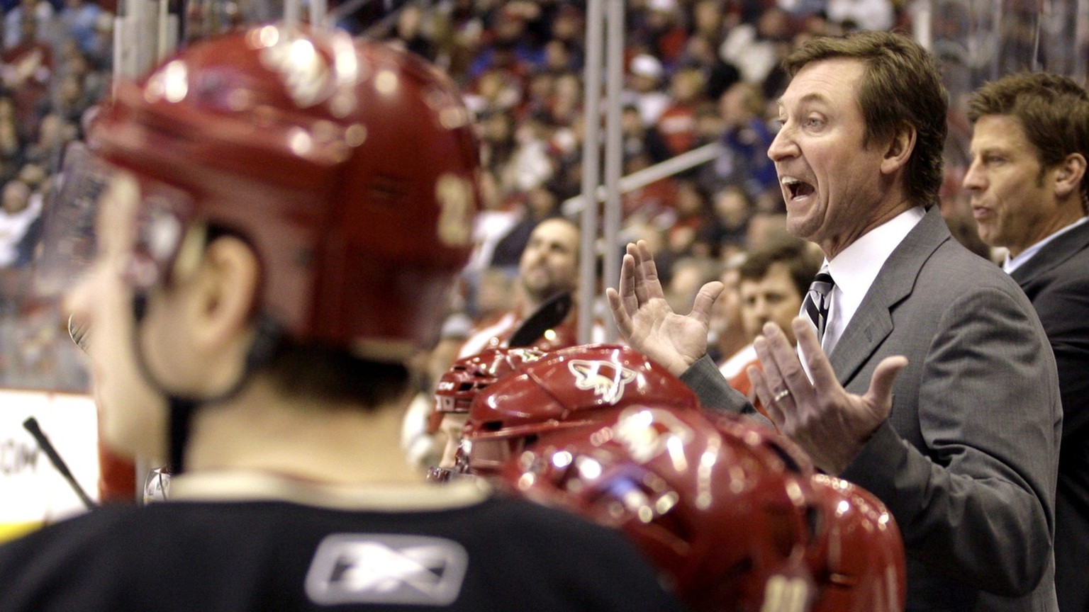 Phoenix Coyotes coach Wayne Gretzky, second from right, argues a call after the referee called a penalty against his team against the Los Angeles Kings in the first period of an NHL hockey game Saturd ...