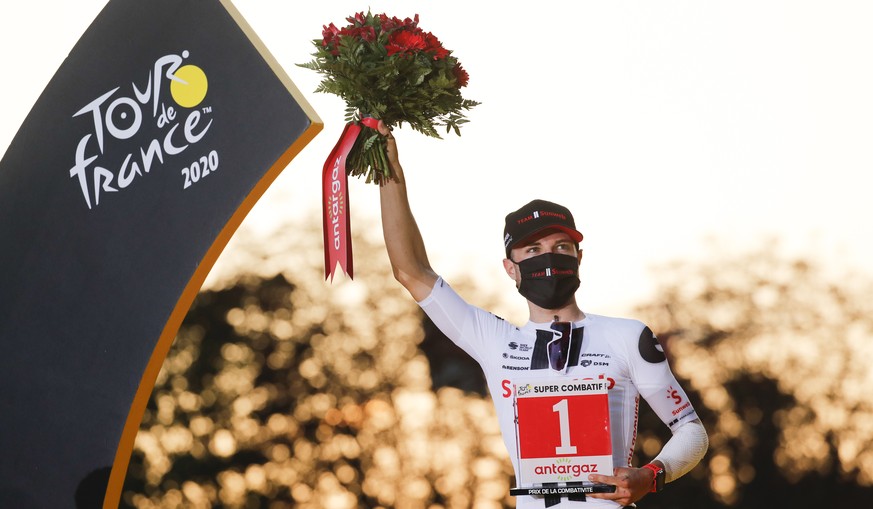 Most combative rider of the Tour de France, Marc Hirschi of Switzerland, celebrates on the podium celebrates on the podium after the twenty-first and last stage of the Tour de France cycling race over ...