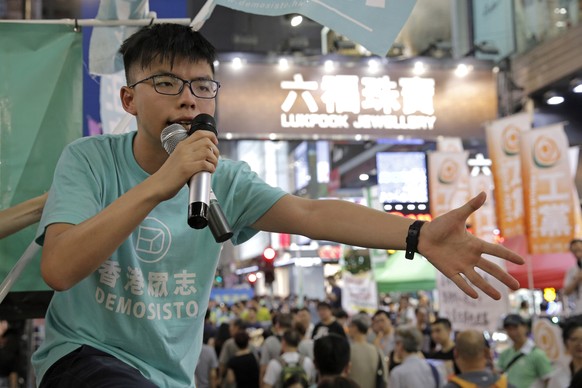 In this June 4, 2017, photo, Hong Kong student activist Joshua Wong urges people to donate money before an annual candlelight vigil at Hong Kong&#039;s Victoria Park. After a security law for Hong Kon ...