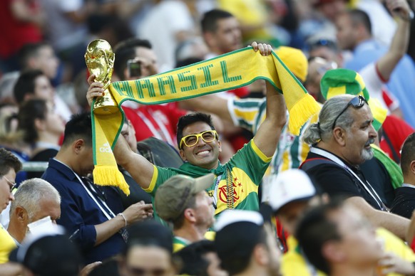 A Brazil fan holds a copy of the World Cup trophy prior to the group E match between Serbia and Brazil, at the 2018 soccer World Cup in the Spartak Stadium in Moscow, Russia, Wednesday, June 27, 2018. ...