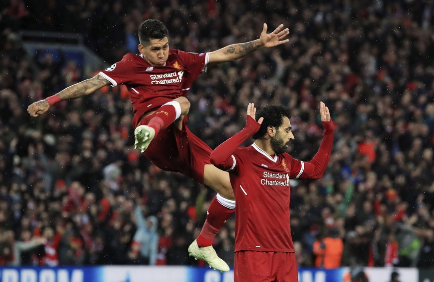 Liverpool&#039;s Mohamed Salah, right, celebrates scoring his side&#039;s second goal of the game with Roberto Firmino during their Champions League, Semifinal first leg soccer match at Anfield in Liv ...