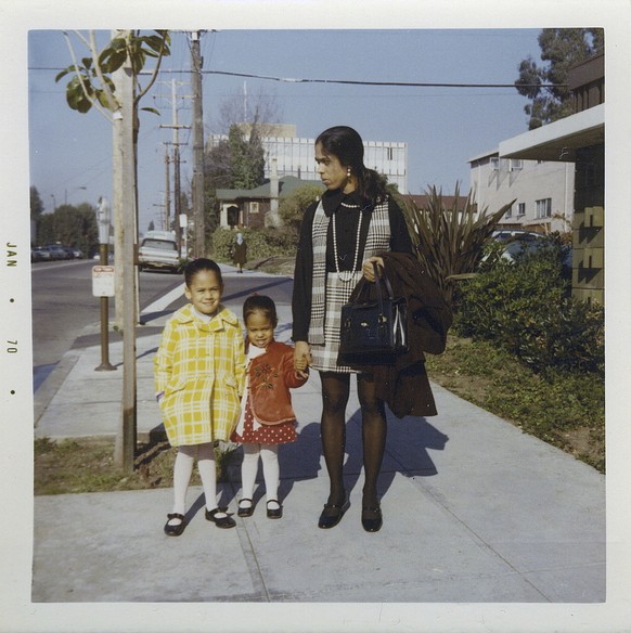 This January 1970 photo provided by the Kamala Harris campaign shows her, left, with her sister, Maya, and mother, Shyamala, outside their apartment in Berkeley, Calif., after her parents&#039; separa ...