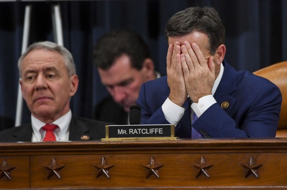 Rep. John Ratcliffe, R-Texas, puts his hands to his face as the hearing entered into the thirteenth hour of the House Judiciary Committee markup of the articles of impeachment against President Donald ...