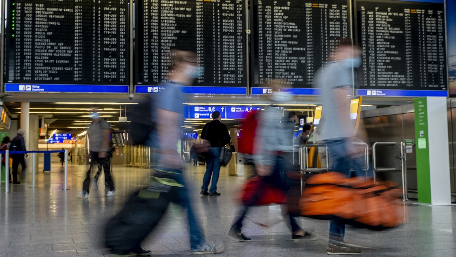 Passenger walk in a terminal at the airport in Frankfurt, Germany, Thursday, Aug. 27, 2020. With more and more tourists coming back from vacation rising numbers over Covid-19 infections are expected a ...