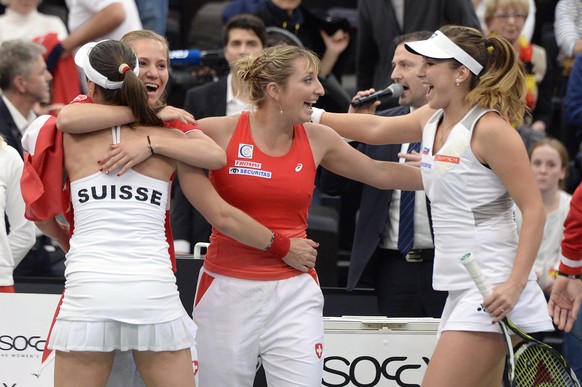 Swiss Team with Martina Hingis, Viktorija Golubic, Timea Bacsinszky and Belinda Bencic, from left, celebrates the victory against Germany during their World Group first round Fed Cup tennis match betw ...