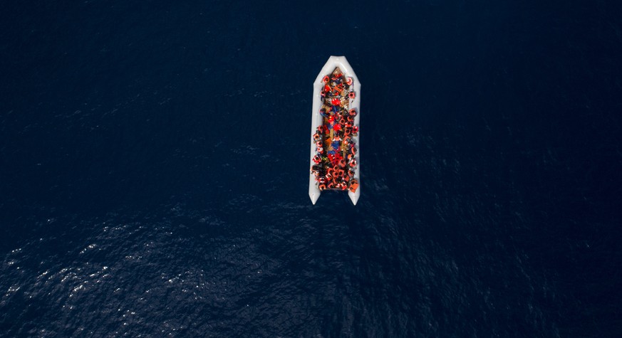 Refugees and migrants wait to be rescued by members of the Spanish NGO Proactiva Open Arms, after leaving Libya trying to reach European soil aboard an overcrowded rubber boat, north of Libyan coast,  ...