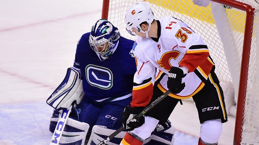 Jan 6, 2017; Vancouver, British Columbia, CAN; Vancouver Canucks goaltender Ryan Miller (30) defends against Calgary Flames forward Alex Chiasson (39) during the third period at Rogers Arena. The Vanc ...