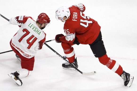 Belarus&#039; forward Artyom Levsha, left, vies for the puck with Switzerland&#039;s defender Michael Fora, right, during the IIHF 2018 World Championship preliminary round game between Switzerland an ...