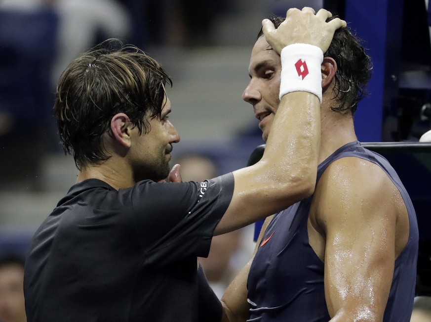 David Ferrer, left, of Spain, talks to Rafael Nadal, also of Spain, after Ferrer retired from their first-round match at the U.S. Open tennis tournament, Monday, Aug. 27, 2018, in New York. (AP Photo/ ...