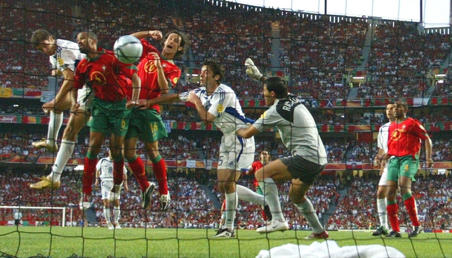 Greek striker Angelos Charisteas (left) scores the 1-0 lead during the Euro 2004 final between Portugal and Greece at Luz stadium in Lisbon on Sunday, 04 July 2004. EPA/ANTONIO SIMOES NO MOBILE PHONE  ...