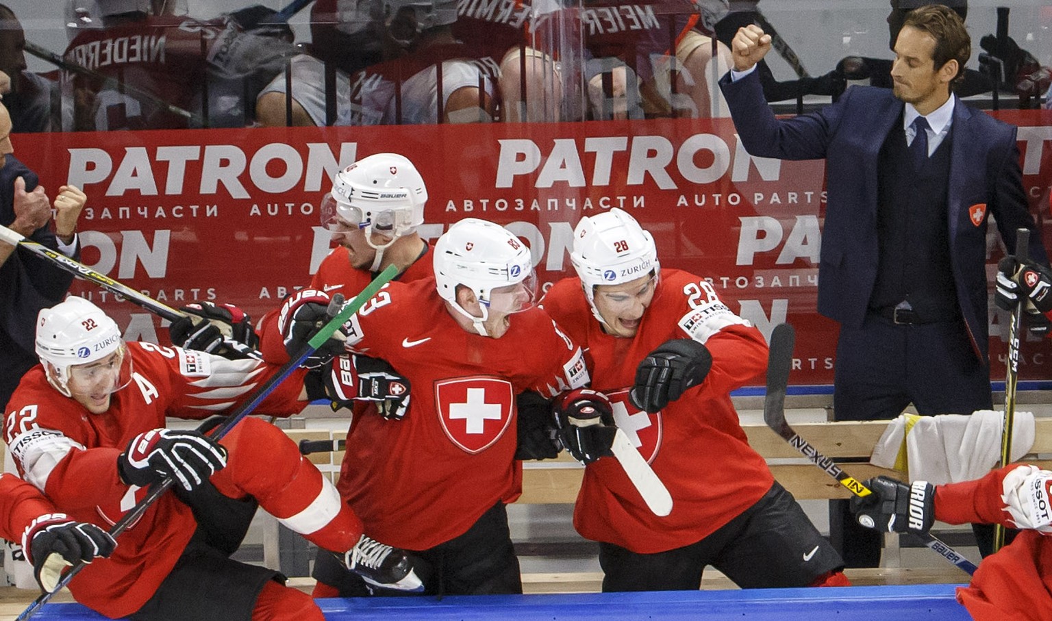 Patrick Fischer,right, head coach of Switzerland national ice hockey team, and Switzerland&#039;s players celebrate their victory after beating Canada, during the IIHF 2018 World Championship semi fin ...
