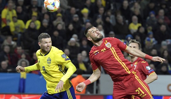 epa07459051 Sweden&#039;s Marcus Berg (L) and Romania&#039;s Dragos Grigore (R) in action during the UEFA Euro 2020 qualifying group F football match between Sweden and Romania at Friends Arena in Sto ...