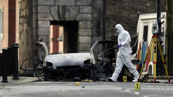 Forensic investigators at the scene of a car bomb blast on Bishop Street in Londonderry, Northern Ireland, Sunday, Jan. 20, 2019. Northern Ireland police and politicians have condemned a &quot;reckles ...