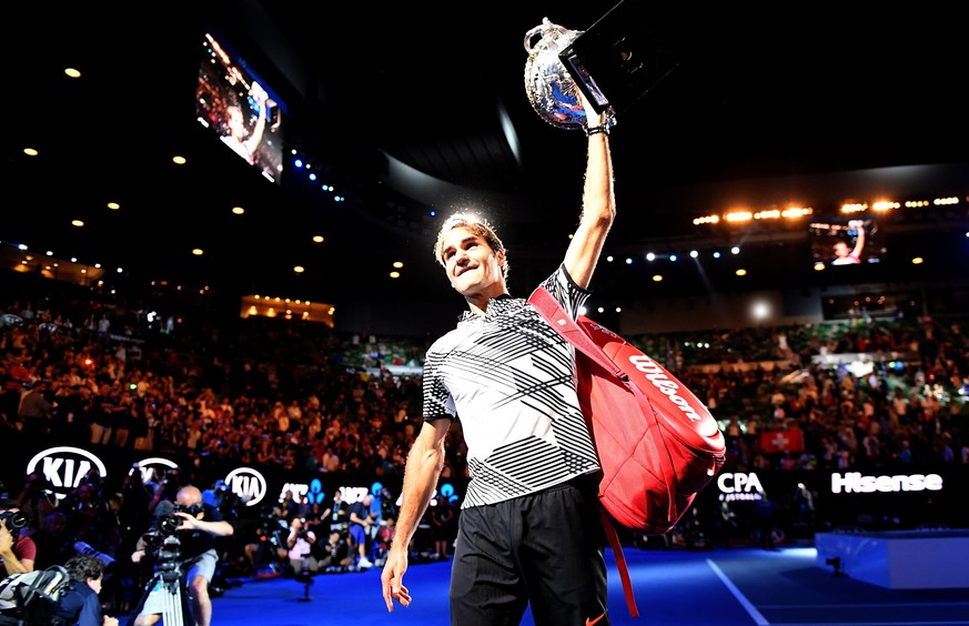 epa05759221 Roger Federer of Switzerland celebrates with the trophy after winning the Men&#039;s Singles final match against Rafael Nadal of Spain at the Australian Open Grand Slam tennis tournament i ...