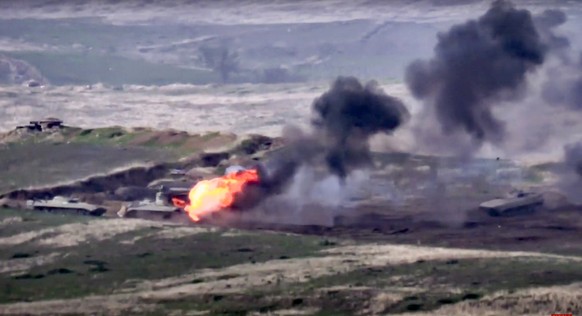 In this image taken from a footage released by Armenian Defense Ministry on Sunday, Sept. 27, 2020, Armenian forces destroy Azerbaijani military vehicle at the contact line of the self-proclaimed Repu ...