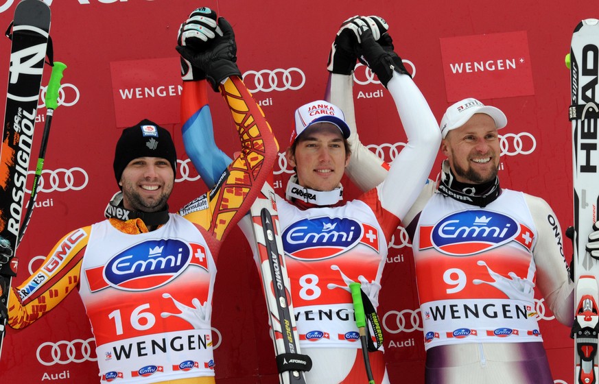 Winner Carlo Janka of Switzerland, is flanked by second placed Manuel Osborne-Paradis of Canada (left) and 3rd placed Marco Buechel of Liechtenstein,(right) on the podium after the men&#039;s ski Wolr ...