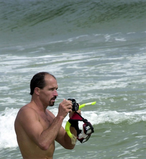 Shark expert Erich Ritter photographs the shallows as he starts his investigation at Langdon Beach, Friday, July 13, 2001, near Pensacola, Fla., where 8-year-old Jessie Arbogast was attacked by a shar ...
