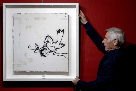 epa08843430 The graffiti painting &#039;Bird with Grenade,&#039; atributed to British anonymous street artist Banksy, is on display in Zwolle, The Netherlands, 26 November 2020. The auction house Hess ...