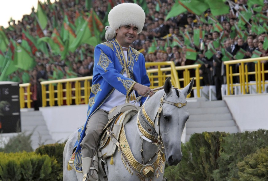 FILE - In this Saturday April 23, 2011 file photo, Turkmenistan&#039;s President Gurbanguli Berdymukhamedov smiles as he rides a horse with a dove on his shoulder at a ceremony in the capital Ashgabat ...