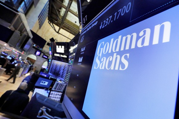FILE - In this Dec. 13, 2016, file photo, the logo for Goldman Sachs appears above a trading post on the floor of the New York Stock Exchange. Goldman Sachs has reached a $3.9B settlement with Malaysi ...